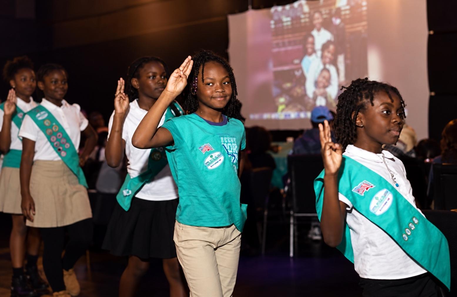 Young people on stage at a community event